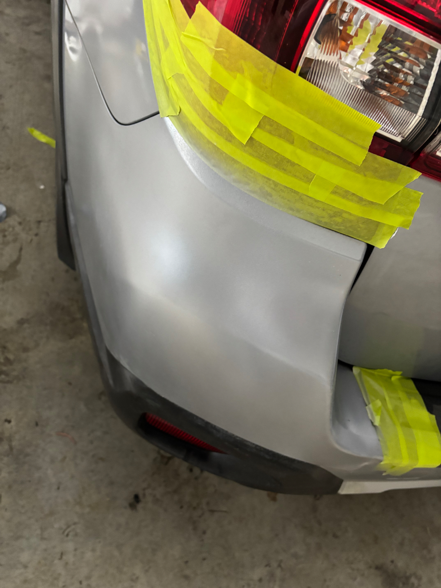 Subaru rear quarter — masked for repair